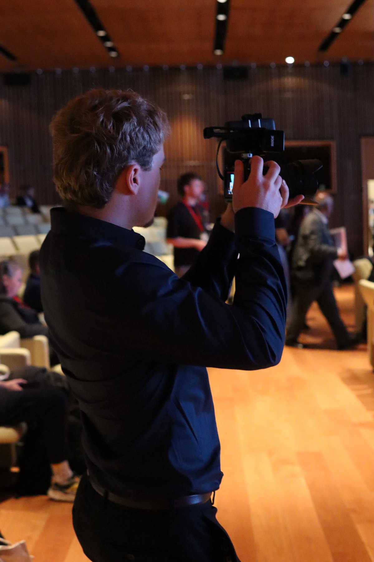 An ARTO camera operator filming at an event