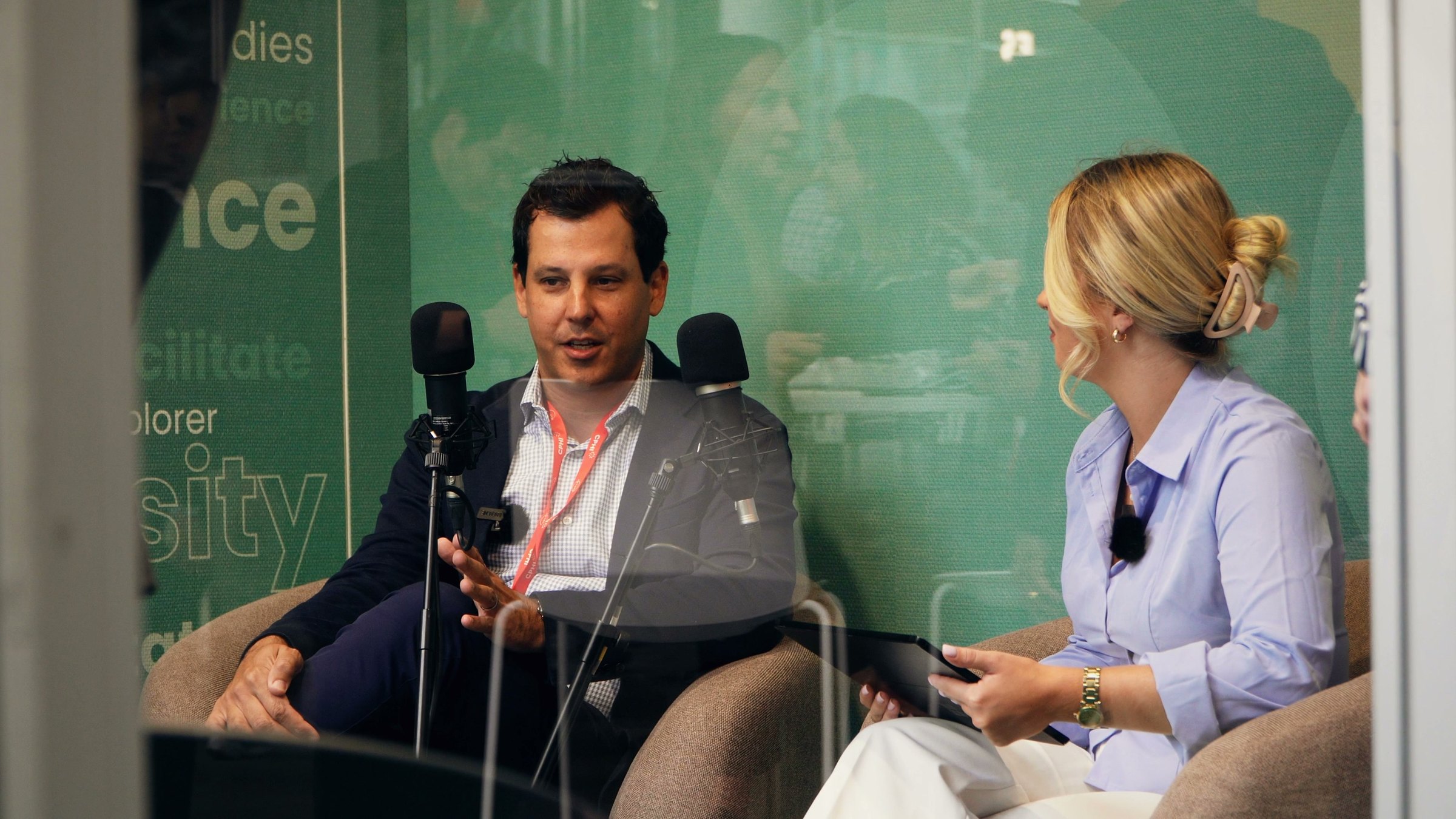An interview in the ARTO studio at CPHI Milan, seen through the glass